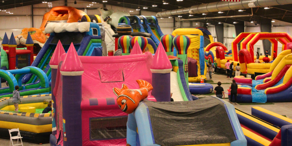 The Event Center at Archer main floor covered with bounce houses, inflatables, obstacle courses and more during WYO Bounce Bash. 